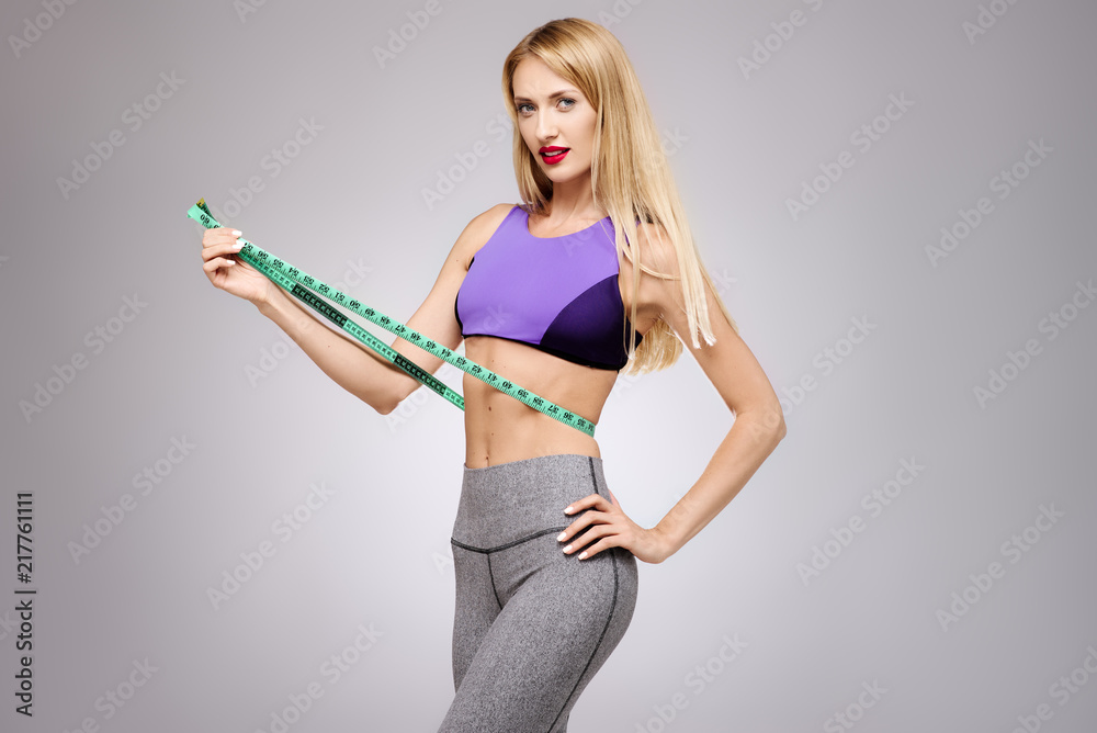 Photo Stock Young beautiful slim girl measuring her waist. Woman body with  measure-beauty, diet, slimming and weight loss concept. Isolated portrait  studio | Adobe Stock